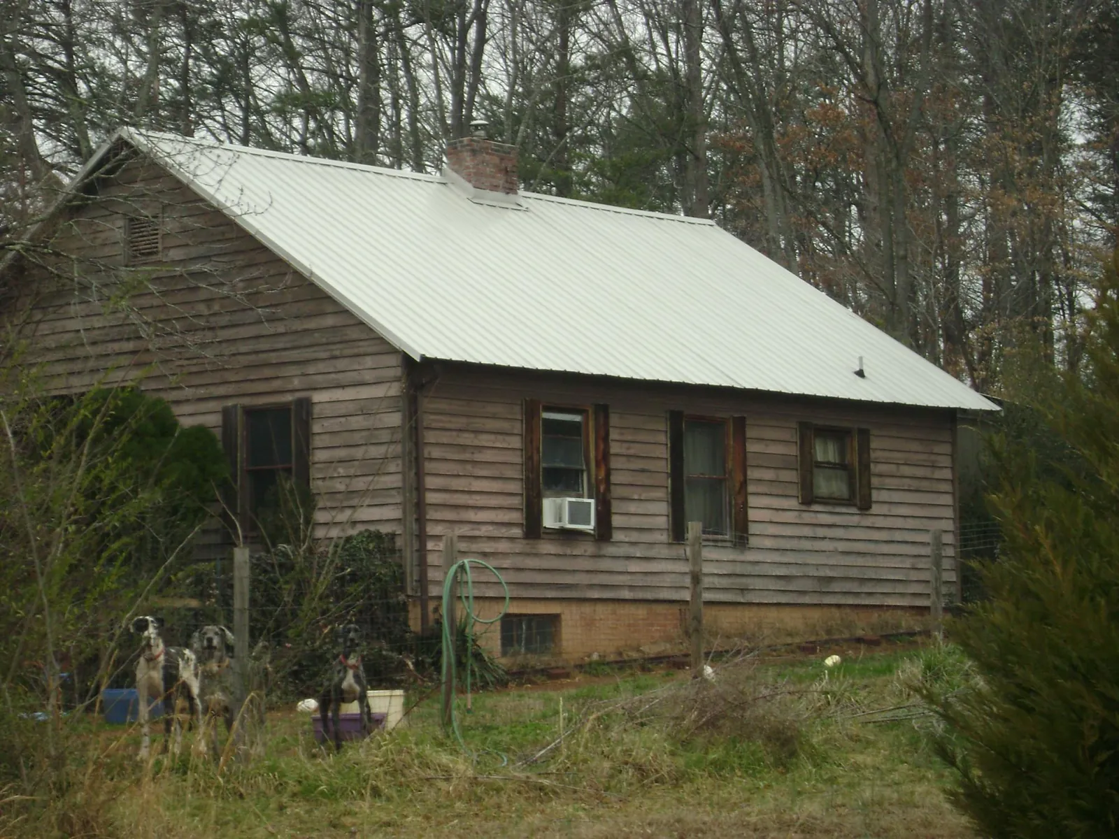 White metal roof on an old wood sided farmhouse, from a Metal Roof Installation job in Barre